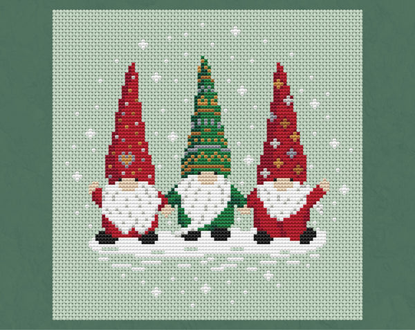 Christmas Gnome Trio cross stitch pattern - three Christmas gonks or tomte holding hands, two in red outfits and one in a green outfit, with white beards and a snowy background. Shown with no border.