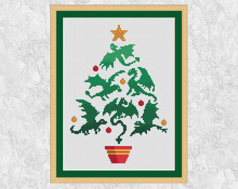 Dragon Christmas Tree cross stitch pattern. Christmas tree shape made up of dragon silhouettes. Shown with frame.