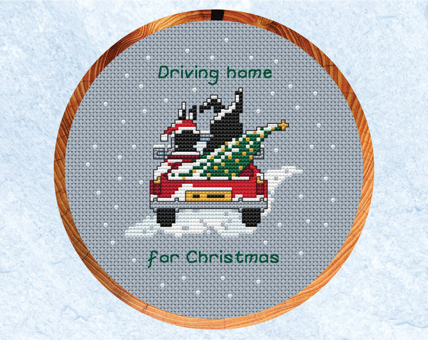 Driving Home for Christmas cross stitch pattern - the two Together Bunnies in a car with a Christmas tree in the back. Shown in hoop.