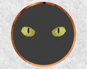 Cat's Eyes cross stitch pattern. Shown in hoop.