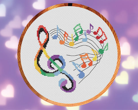 Heart of Music cross stitch pattern. Treble clef and music notes making the shape of a heart. Shown in hoop.