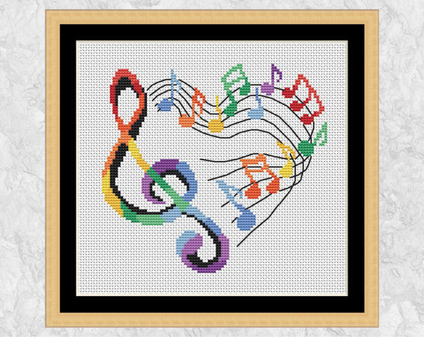Heart of Music cross stitch pattern. Treble clef and music notes making the shape of a heart. Shown in frame.