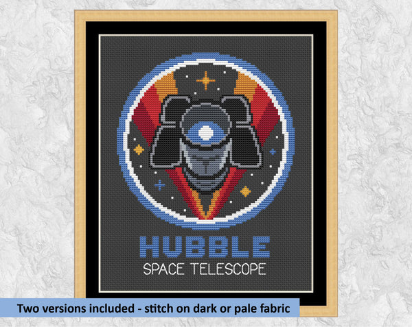 Hubble Space Telescope cross stitch pattern. Shown on black fabric in frame with the text 'Two versions included - stitch on dark or pale fabric'