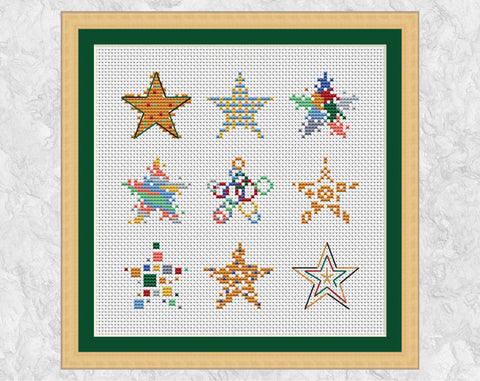 Nine mini Christmas stars cross stitch pattern - each in different styles. Shown with frame.
