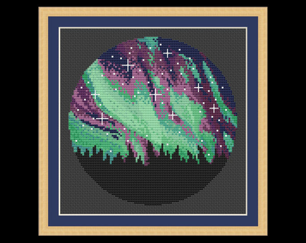 Northern Lights cross stitch pattern. Shown in frame.