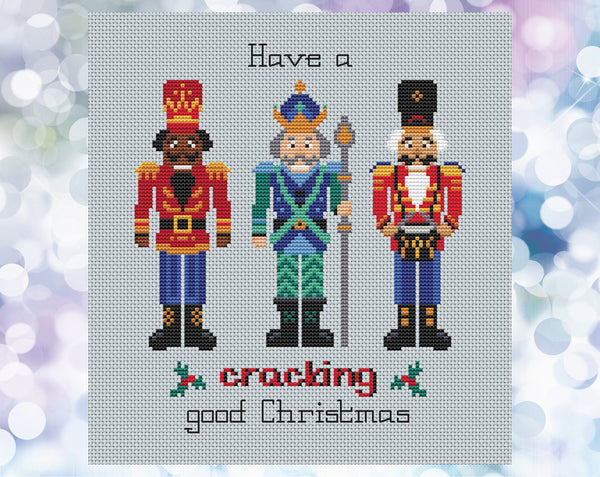 Nutcracker cross stitch pattern. Three Nutcracker soldiers with the words 'Have a cracking good Christmas'. Shown without frame.