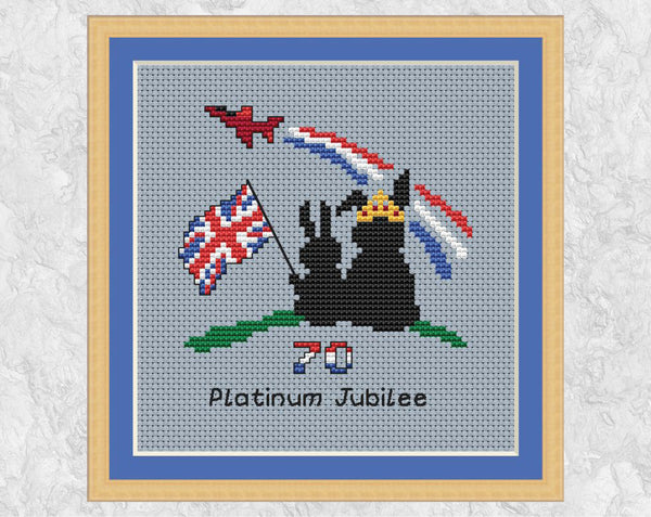 Platinum Jubilee cross stitch pattern. Two bunnies watching with a union flag watching a flypast. Shown with frame.