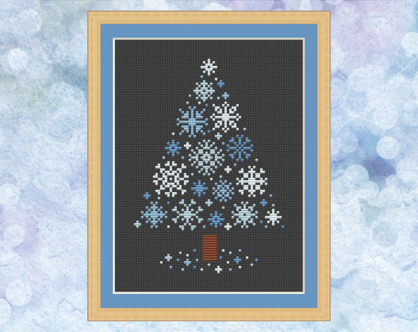 Snowflakes Christmas Tree cross stitch pattern - xmas tree made up of small snowflakes. Version with pale blue snowflakes on black fabric, shown with frame.
