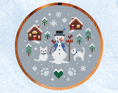 Snowman and Snowcats cross stitch pattern. Shown in hoop.