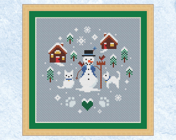 Snowman and Snowcats cross stitch pattern. Shown in frame.
