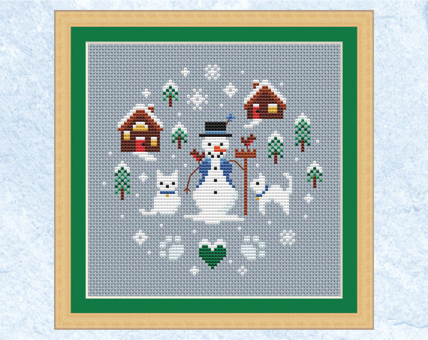 Snowman and Snowcats cross stitch pattern. Shown in frame.
