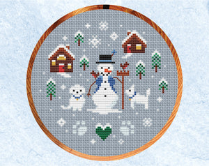 Snowman and Snowdogs cross stitch pattern. Shown in hoop.