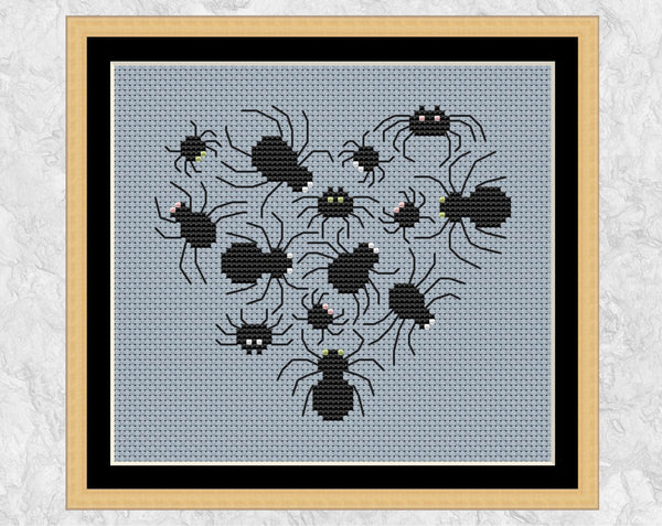 Spide Heart cross stitch pattern. Shown with frame.