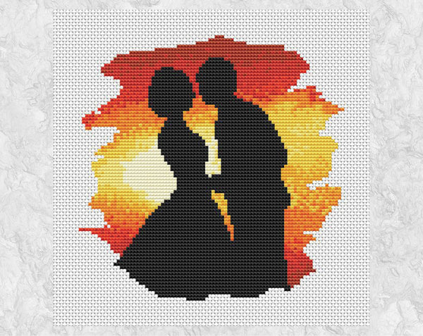Wedding cross stitch pattern of the silhouette of a bride and groom about to kiss against the backdrop of a sunset. Shown without frame.