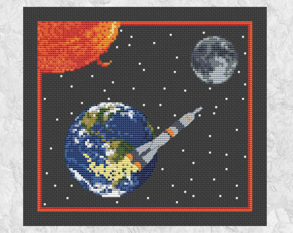 'To the Moon' - Space cross stitch pattern showing rocket, Earth, Sun and Moon. Shown on black fabric without frame.