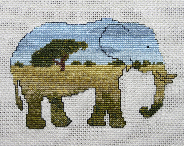 Elephant cross stitch kit - everything you need to stitch a silhouette of an elephant filled with a scene of the African savannah. Straight view of stitched piece.