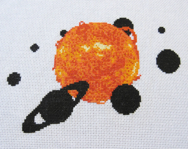 Solar System - Astronomy cross stitch pattern - Sun and planets. Angled view of stitched piece.