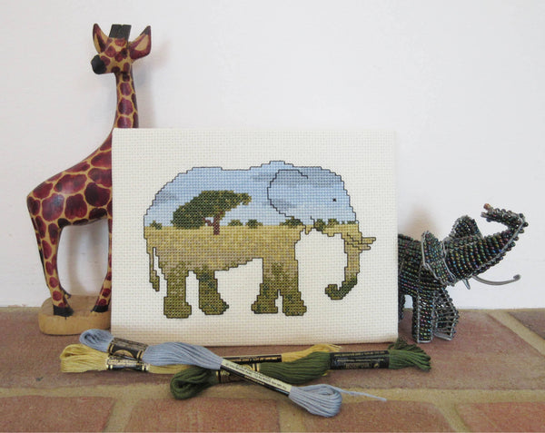 Elephant cross stitch kit - everything you need to stitch a silhouette of an elephant filled with a scene of the African savannah. Stitched piece with props.