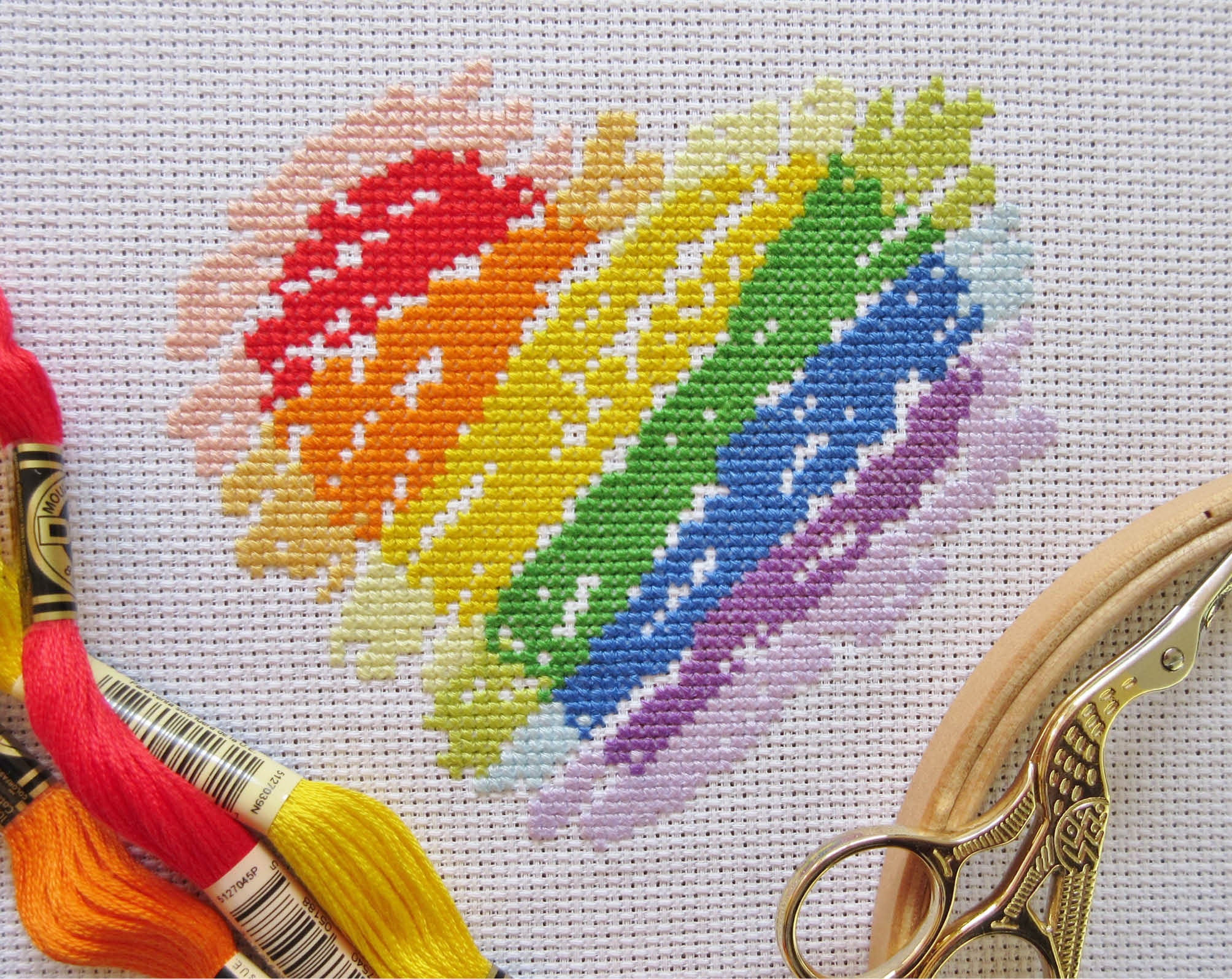 Brushstrokes Rainbow Heart cross stitch pattern - stitched piece with props