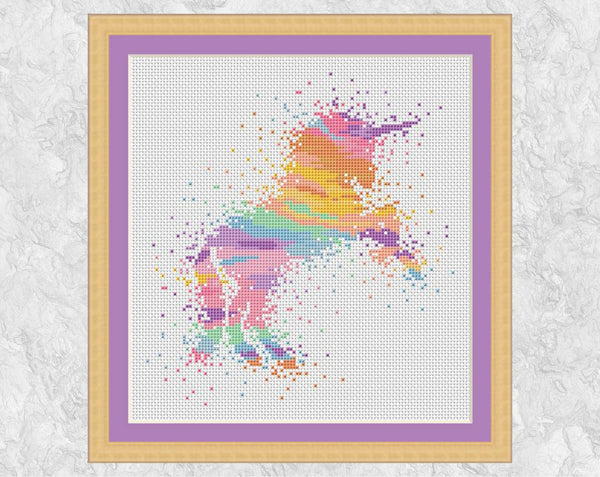 Watercolour Unicorn cross stitch pattern - magical unicorn in rainbow pastel colours. Shown with frame.