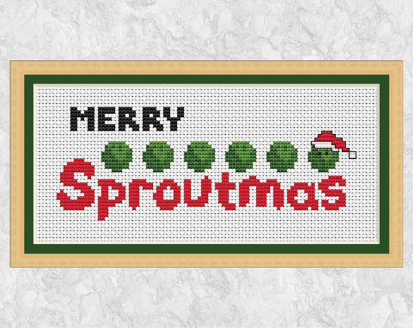 Christmas cross stitch pattern of a row of sprouts, one wearing a Santa hat, and the words 'Merry Sproutmas'. Shown with frame.