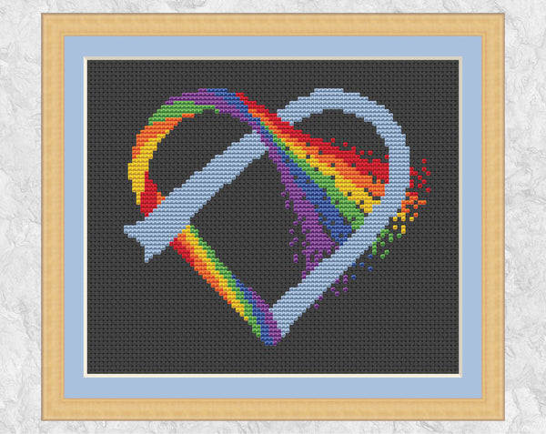 Knotted Rainbow Heart cross stitch pattern on black fabric, with frame