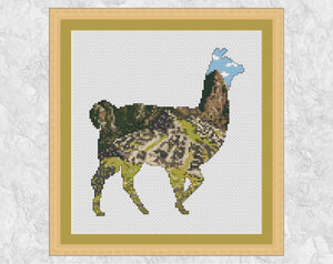 Cross stitch pattern PDF of the silhouette of a llama, filled with a scene of the world famous ancient city of Machu Picchu, set dramatically amongst Peruvian mountains. Shown with frame.