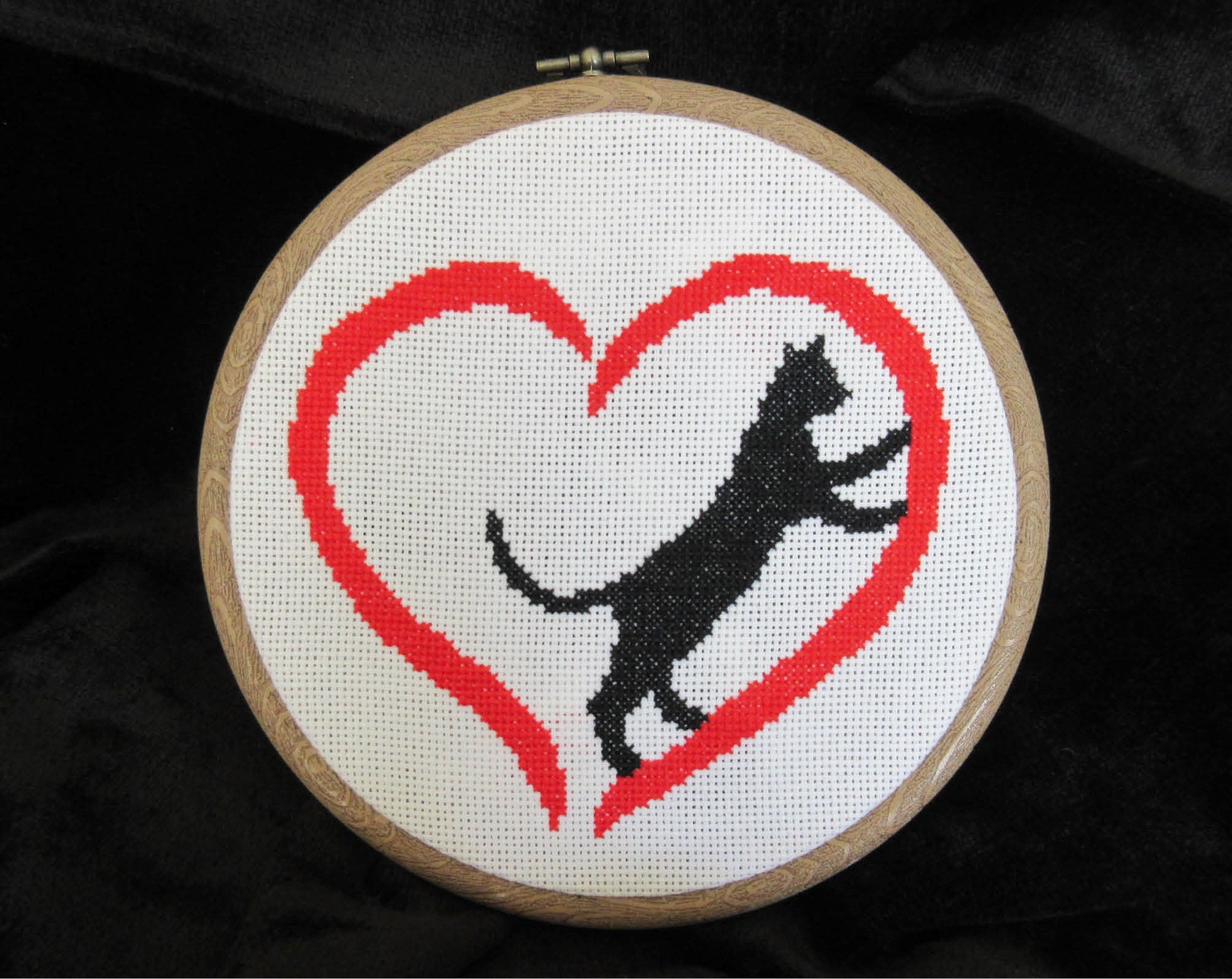 Cross stitch pattern PDF of a cat climbing inside a heart - stitched piece in hoop