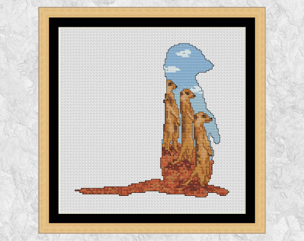 Cross stitch pattern PDF of the silhouette of a meerkat, filled with three more meerkats watching astutely for any trouble! Shown with frame.