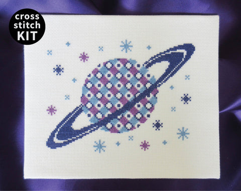Patterned Saturn cross stitch kit - design of the planet Saturn filled with a geometric design in shades of blue and purple.