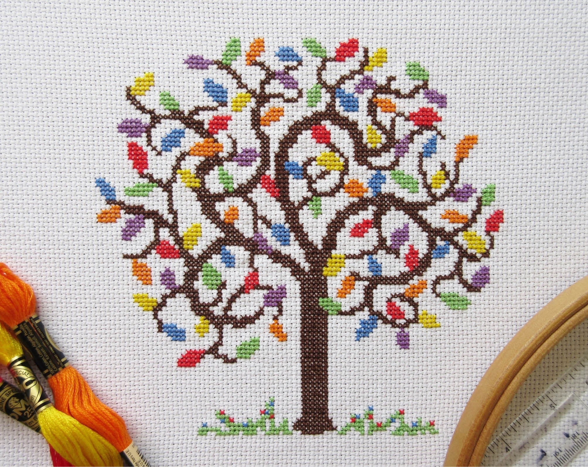 Rainbow Tree cross stitch pattern - stitched piece with props