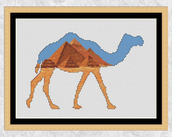 Cross stitch pattern of a camel silhouette filled with a desert scene of the famous Pyramids in Egypt. Shown with frame.