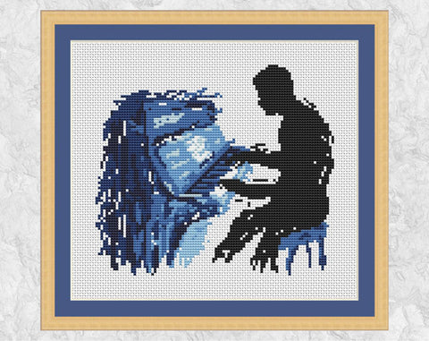 Splattered paint male piano player cross stitch pattern. Shown with frame.