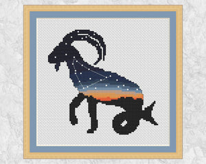 Cross stitch pattern of Capricorn, the sea goat, filled with a scene of the constellation Capricornus against the last of a sunset. With frame.