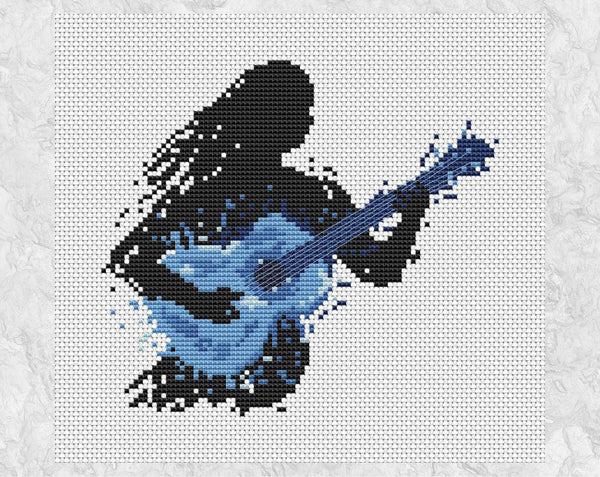 Female guitarist music cross stitch pattern - splattered paint style. Shown without frame.