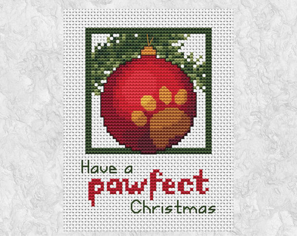 Cross stitch pattern of a red bauble with a gold paw print on it, hanging from a branch with the words 'Have a pawfect Christmas'. Shown without frame.