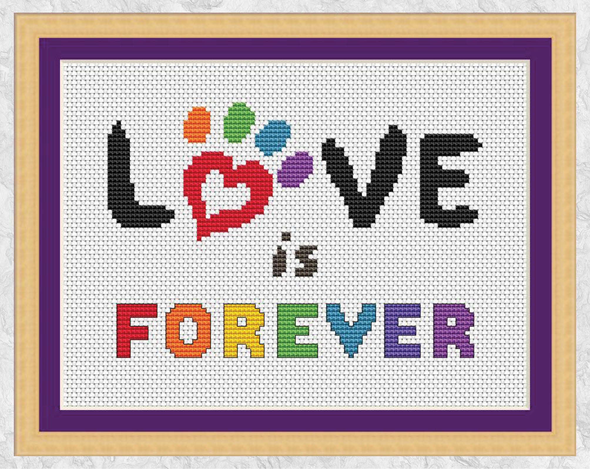 Cross stitch pattern of the words "Love is Forever" with a paw print heart and the colours of the rainbow - with frame