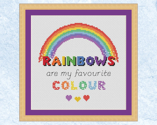 Cross stitch pattern of the quote 'Rainbows are my Favourite Colour' with a rainbow and hearts. UK spelling version displayed in frame.