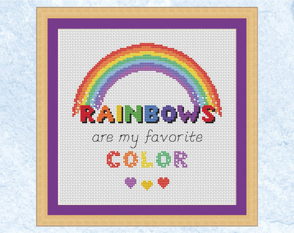 Cross stitch pattern of the quote 'Rainbows are my Favourite Colour' with a rainbow and hearts. US spelling version displayed with frame.