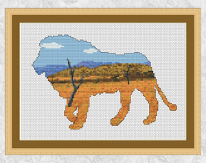 African Plains Lion: Cross stitch pattern of the silhouette of a lion filled with a scene of African plains and bushland, with distant mountains. Shown with frame.