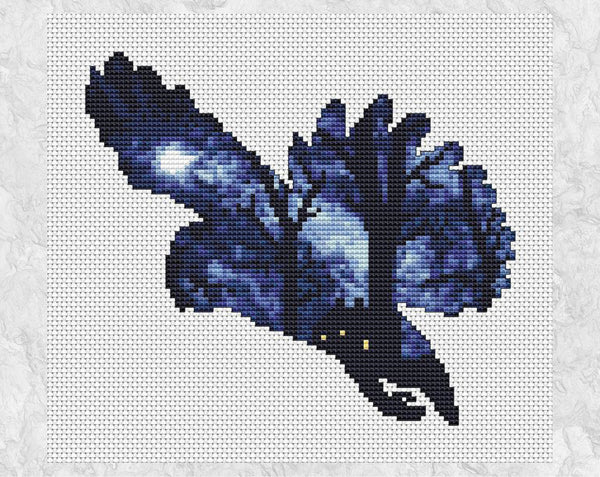 Cross stitch pattern of the silhouette of a swooping owl, filled with a scene of a woodland illuminated by moonlight, with a cottage nestled amongst the trees. Shown without frame.
