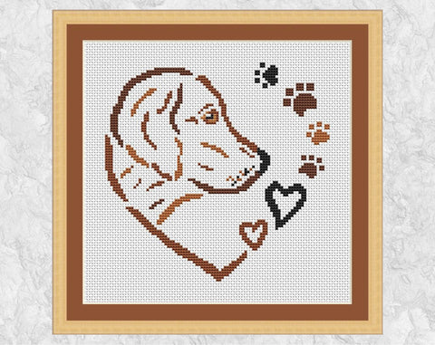 Cross stitch pattern PDF of a dog, hearts and paw prints forming a larger heart. Shown with frame.