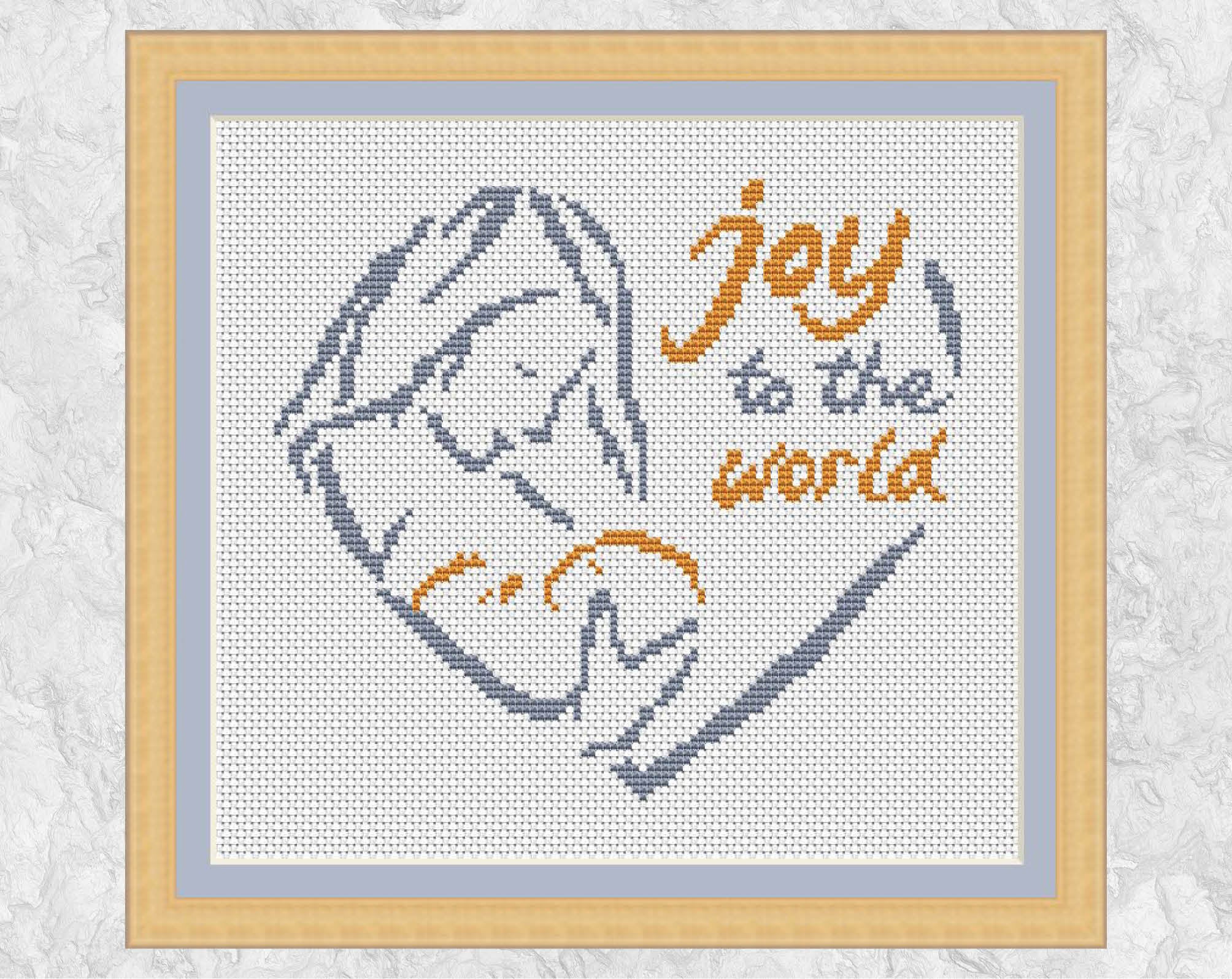 Nativity Heart cross stitch pattern - sketched outline design of Mary holding the baby Jesus, with the words 'Joy to the world'. Shown with frame.