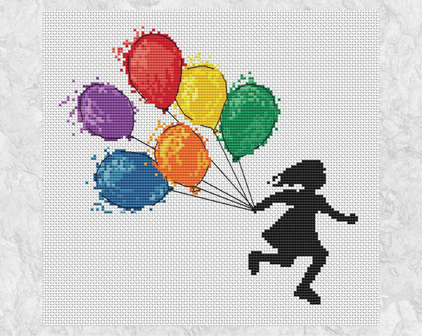 Cross stitch pattern of a girl running with watercolour effect balloons in rainbow colours. Shown without frame.