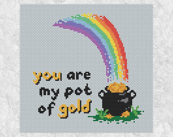 Cross stitch pattern of a rainbow falling on a pot of gold, with the words 'you are my pot of gold'. Shown without frame.