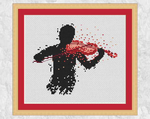 Modern art cross stitch pattern of a male violin player. Shown with frame.