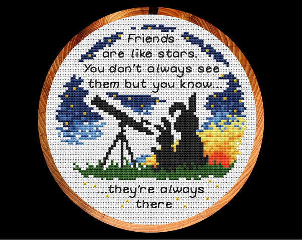 Cross stitch pattern of two bunnies looking through a telescope, with the words 'Friends are like stars. You don't always see them but you know they're always there." Shown in hoop.