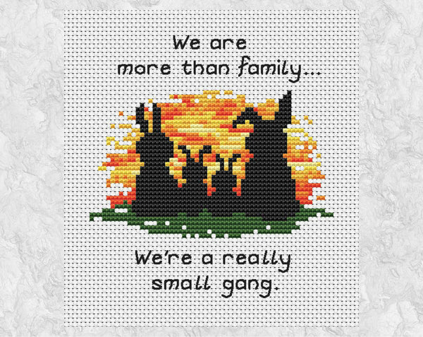 Cross stitch pattern of four bunny silhouettes against a sunset, with the words "We are more than family... We're a really small gang.". Shown without frame.