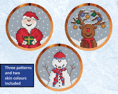 Set of three mini Christmas cross stitch patterns - Santa, reindeer and snowman. Shown in hoops with white-skinned Santa variation.