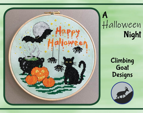 'A Halloween Night' cross stitch pattern - featuring a bat, moon, cauldron, pumpkins, black cat, spiders and the words 'Happy Halloween'.